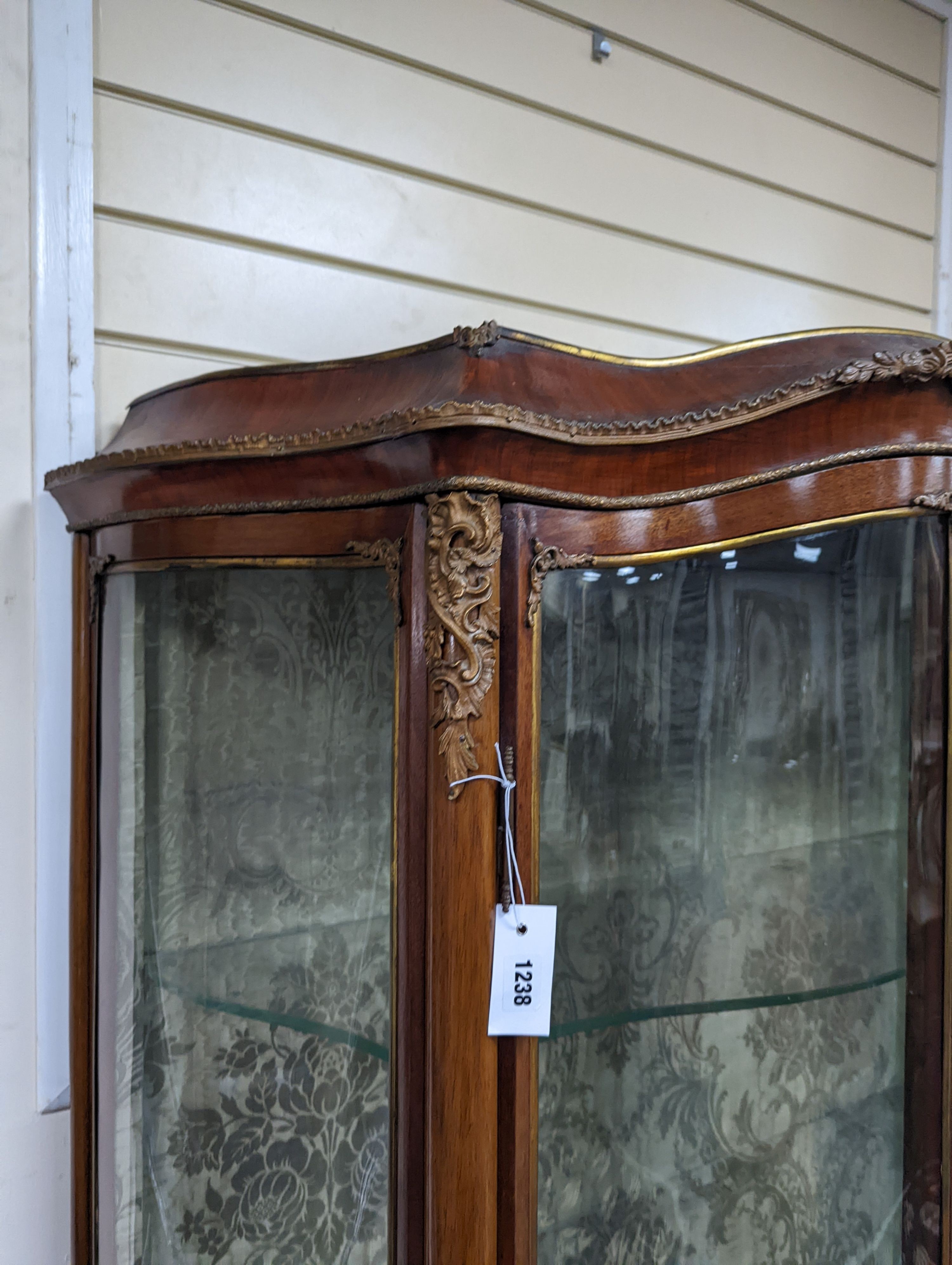 A Louis XV style mahogany serpentine vitrine with Vernis Martin style panels and gilt metal mounts, width 108cm, depth 46cm, height 193cm